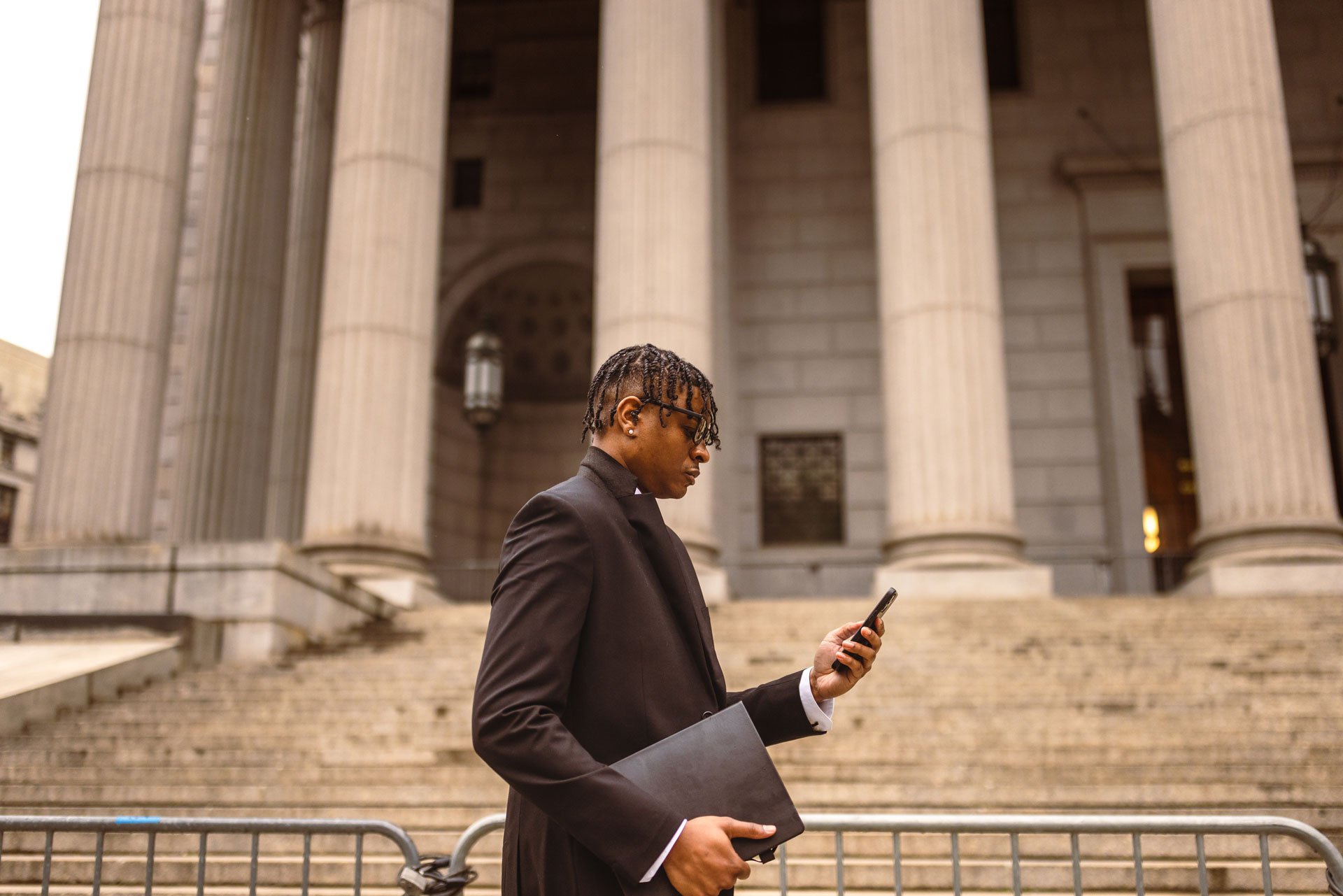 Man on the phone in front of a government building